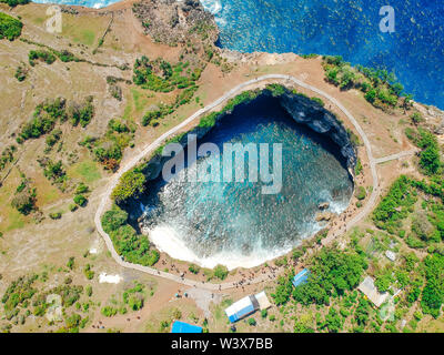 Aerial drone top view of Broken Beach In Nusa Penida, Bali, Indonesia. Overhead View Of Rocky Coast And Coves Stock Photo