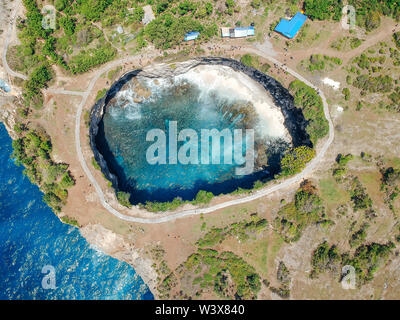 Aerial drone top view of Broken Beach In Nusa Penida, Bali, Indonesia. Overhead View Of Rocky Coast And Coves Stock Photo