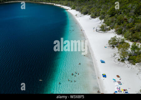 People relaxing and swimming in blue water Lake Mckenzie Fraser Island Queensland Australia