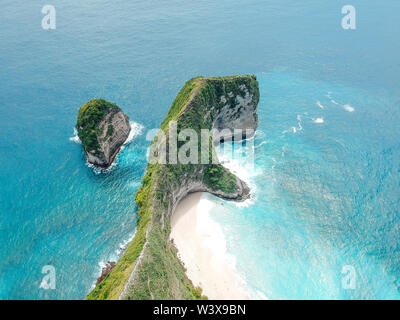 Aerial drone view of blue ocean view of seashore at Manta Bay or at Kelingking Beach on Nusa Penida Island, Bali, Indonesia Stock Photo