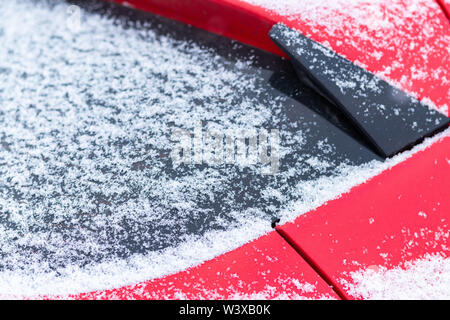 Snow covered car window, macro, close up. Antifreeze was not used. Vehicles in snow. Winter time is coming. Bad weather conditions Stock Photo
