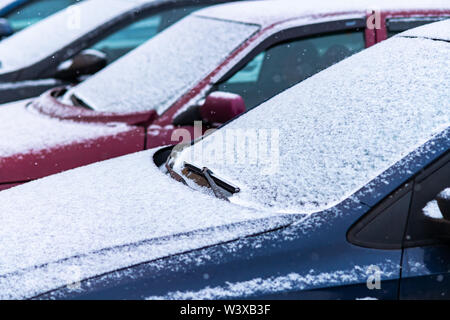 Snow covered cars in the parking, close up. Antifreeze was not used. Vehicles in snow. Winter time is coming. Bad weather conditions Stock Photo