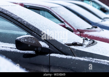 Snow covered cars in the parking, close up. Antifreeze was not used. Vehicles in snow. Winter time is coming. Bad weather conditions Stock Photo