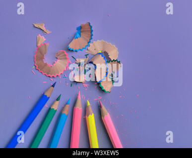 close on wooden colorful pencils sharpened on colored paper background Stock Photo