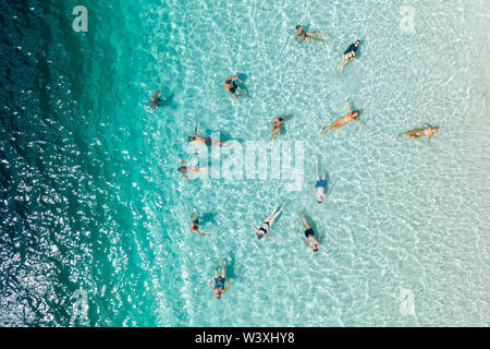 People relaxing and swimming in blue water Lake Mckenzie Fraser Island Queensland Australia