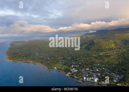 Coast island Camiguin, view from above. Beach with volcanic sand. Seascape, island with dense tropical forest. Stock Photo