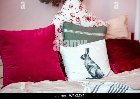 many different pillows lying on the bed Stock Photo