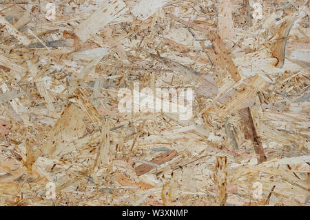 OSB boards are made of wood chips. Top view OSB veneer background. Abstract background. Stock Photo