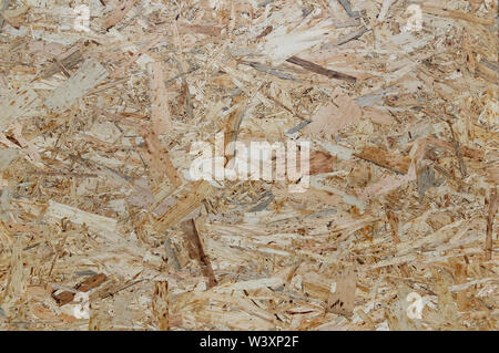 OSB boards are made of wood chips. Top view OSB veneer background. Abstract background. Stock Photo