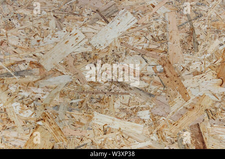 OSB boards are made of wood chips. Top view OSB veneer background. Abstract background. Stock Photo
