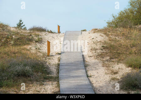 wooden pathway leading through dunes shore of the Baltic sea in Lithuania Stock Photo