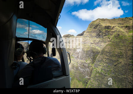 A helicopter tour is a breathtaking way to see the amazing aerial scenery of Kauai, Hawaii, USA including the famed Na Pali Coast and  Waimea Canyon. Stock Photo