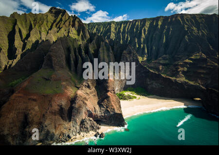 Honopo Beach is sheltered by 1200 foot cliffs; A helicopter tour is a breathtaking way to see amazing aerial scenery of Kauai, Hawaii's Napali Coast Stock Photo