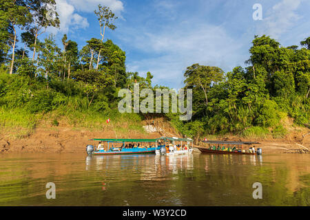 Tourists travelling by boat on the River Tambopata in the Amazonia region of Peru, South America Stock Photo