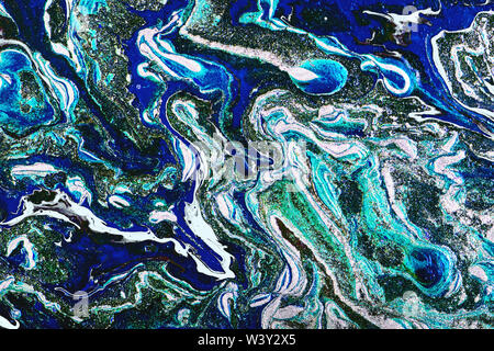 Liquid marbling paint background. Fluid art painting abstract texture, blue, white, black, gold and turquoise. Color mix. Stock Photo