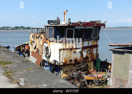 Old decommissioned trawler awaits the shipbreakers alongside the wharf at Glasson Dock on the estuary of the River Lune, Lancashire Stock Photo