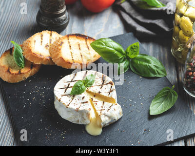 Camembert cheese grill ,on black stone background Stock Photo