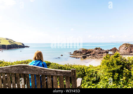 Looking out to sea, dreaming, wanderlust, day dreaming, contemplating, despair, hope, thoughtful, alone with thoughts, alone, sat on bench, woman Stock Photo