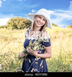 Lifestyle environmental portrait. Latvian model  with flowers. Stock Photo