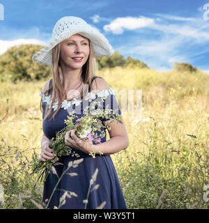 Lifestyle environmental portrait. Latvian model  with flowers. Stock Photo