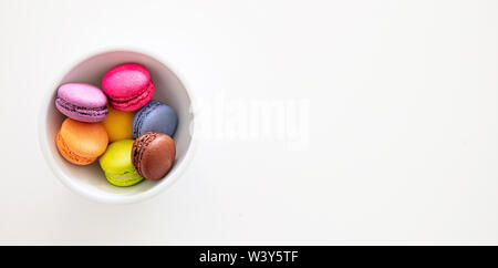Macarons pastel colors with chocolate cream on white background, top view, banner, copy space Stock Photo