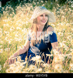 Lifestyle environmental portrait. Latvian model in field of flowers. Stock Photo