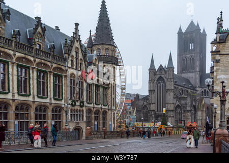 The west end of Saint Nicholas' Church (Sint-Niklaaskerk) and part of Old Post Office building, viewed from St Michaels bridge in in foggy winter morn Stock Photo