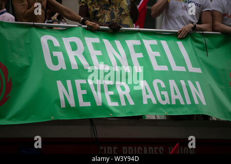 LONDON, UK - July 6th 2019: People hold a Grenfell never again sign in memory of the genfell tower disaster Stock Photo