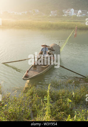 Jiande, China. 18th July 2019. Shao Zhulian displays traditional fish-catching skill in Zhijiang Village of Xiaya Town in Jiande, east China's Zhejiang Province, July 18, 2019. The natural beauty of Xiaya Town attracts numerous tourists, including groups of photography enthusiasts to shoot pictures here. The rise of tourism has created a hunger for models that can display traditional way of fish-catching. Tang Linglong and Shao Zhulian are a couple who work as 'fishing models' in Xiaya Town. Credit: Xinhua/Alamy Live News Stock Photo