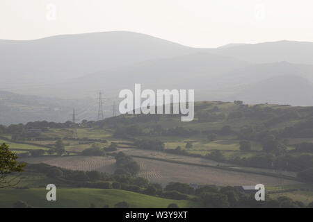 A view along the Vale of Conwy to the mountains of Snowdonia on a summer evening near the village of Eglwysbach Conwy North Wales Stock Photo