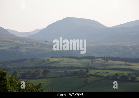 A view along the Vale of Conwy to the mountains of Snowdonia on a summer evening near the village of Eglwysbach Conwy North Wales Stock Photo