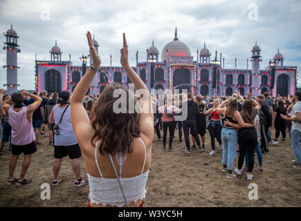 Neustadt Glewe, Germany. 12th July, 2019. Visitors dance in front of the main stage of the electro festival 'Airbeat One'. The festival is one of the largest electronic music festivals in Northern Germany and, according to the organizers, had 180,000 visitors over several days last year. Credit: Jens Büttner/dpa-Zentralbild/ZB/dpa/Alamy Live News Stock Photo