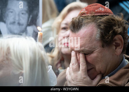 Buenos Aires, Argentina. 18th July, 2019. Participants in a commemoration ceremony mourn the 25th anniversary of the bombing of the Asociación Mutual Israelita Argentina building in Buenios Aires on 18 July 1994, which killed 87 people and injured over 100. It was the worst bomb attack in the history of Argentina. Credit: Ralf Hirschberger/dpa-Zentralbild/dpa/Alamy Live News Stock Photo