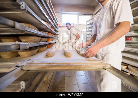 bakers preparing the dough for products In a traditional bakery Stock Photo