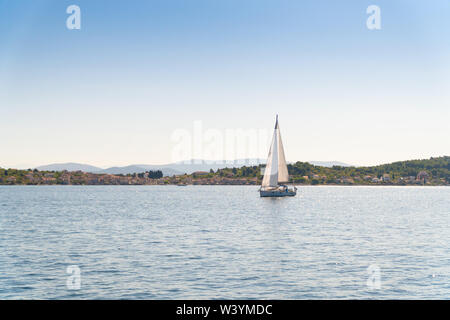 Lonely Yacht sailing on opened sea off the coast of Croatia Stock Photo