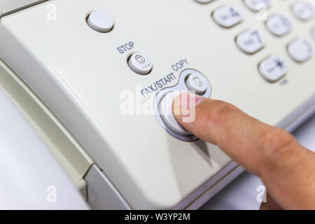 hand man are using a fax machine in the office Business concept Stock Photo