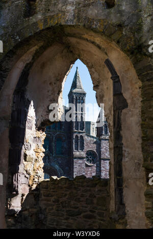 St Davids Cathedral Pembrokeshire. Viewed from one of the arched windows in the ruins of the Bishops palace. Stock Photo
