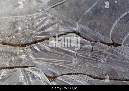 Close-up of thin ice on a puddle. Stock Photo