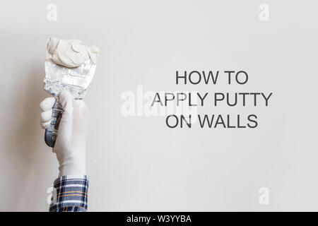 How to apply putty on walls. Stock Photo