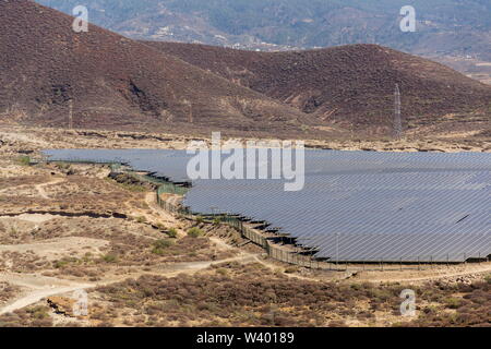 Blue solar panels at photovoltaics power station farm, future innovation energy concept, clear blue sky background, Granadilla, Tenerife Stock Photo