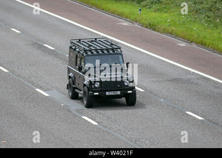 2015 black Land Rover Defender 110 XS TD D/C; UK Vehicular traffic, transport, modern, saloon cars, south-bound on the 3 lane M6 motorway highway. Stock Photo