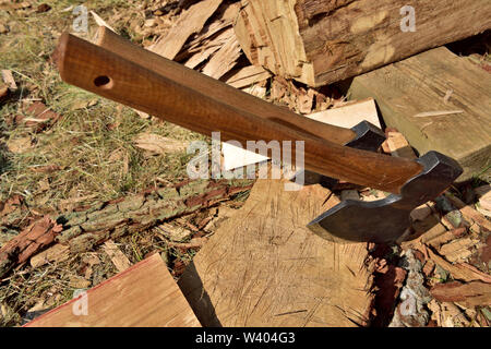 Two hand axes stuck in the end of a log Stock Photo