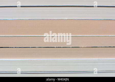 Side view of multiple old and yellowed stacked books background Stock Photo
