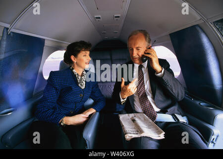 Businessman in business woman on their private plane Stock Photo