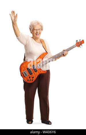 Full length portrait of an elderly female guitarist with an electric bass guitar waving at the camera isolated on white background Stock Photo