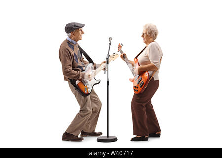 Full length shot of a senior man and woman playing electric guitars isolated on white background Stock Photo