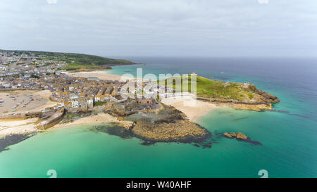 Aerial view of picturesque seaside town of St Ives with sandy beaches by turquoise sea, small fishing port, fortified headland,  in Cornwall , south e Stock Photo