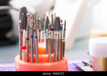 A set of cutters for the device for manicure and tools for nail care on the table Stock Photo