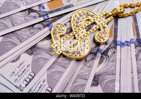 Gold Dollar Sign Necklace on a United States Dollars Banknotes. Financial business background. Stock Photo