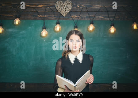 Tutoring is way you explain information and way your students react. Group of attentive adult students with teacher in classroom at training. Concept Stock Photo